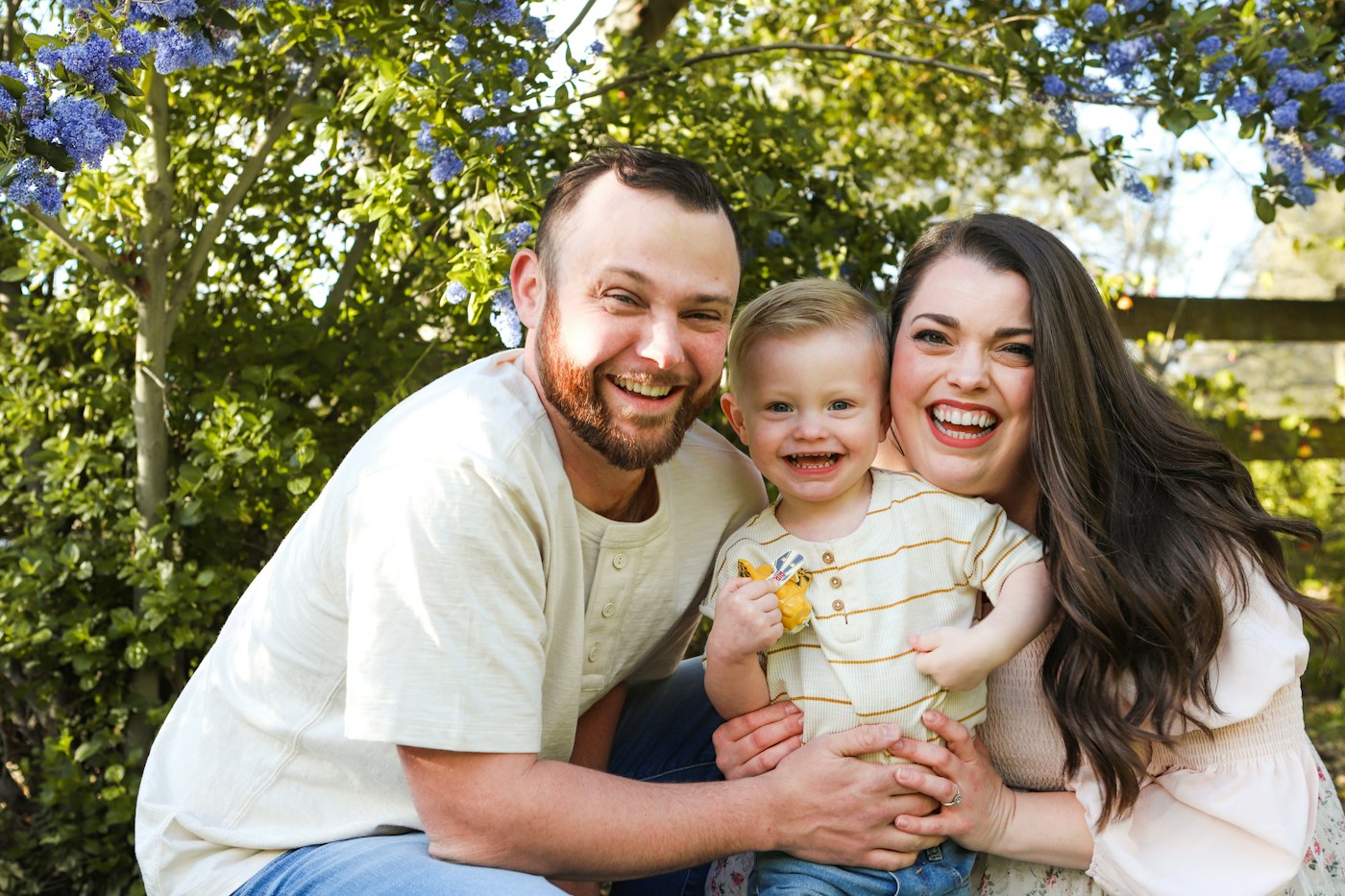 A family laughing together outdoors