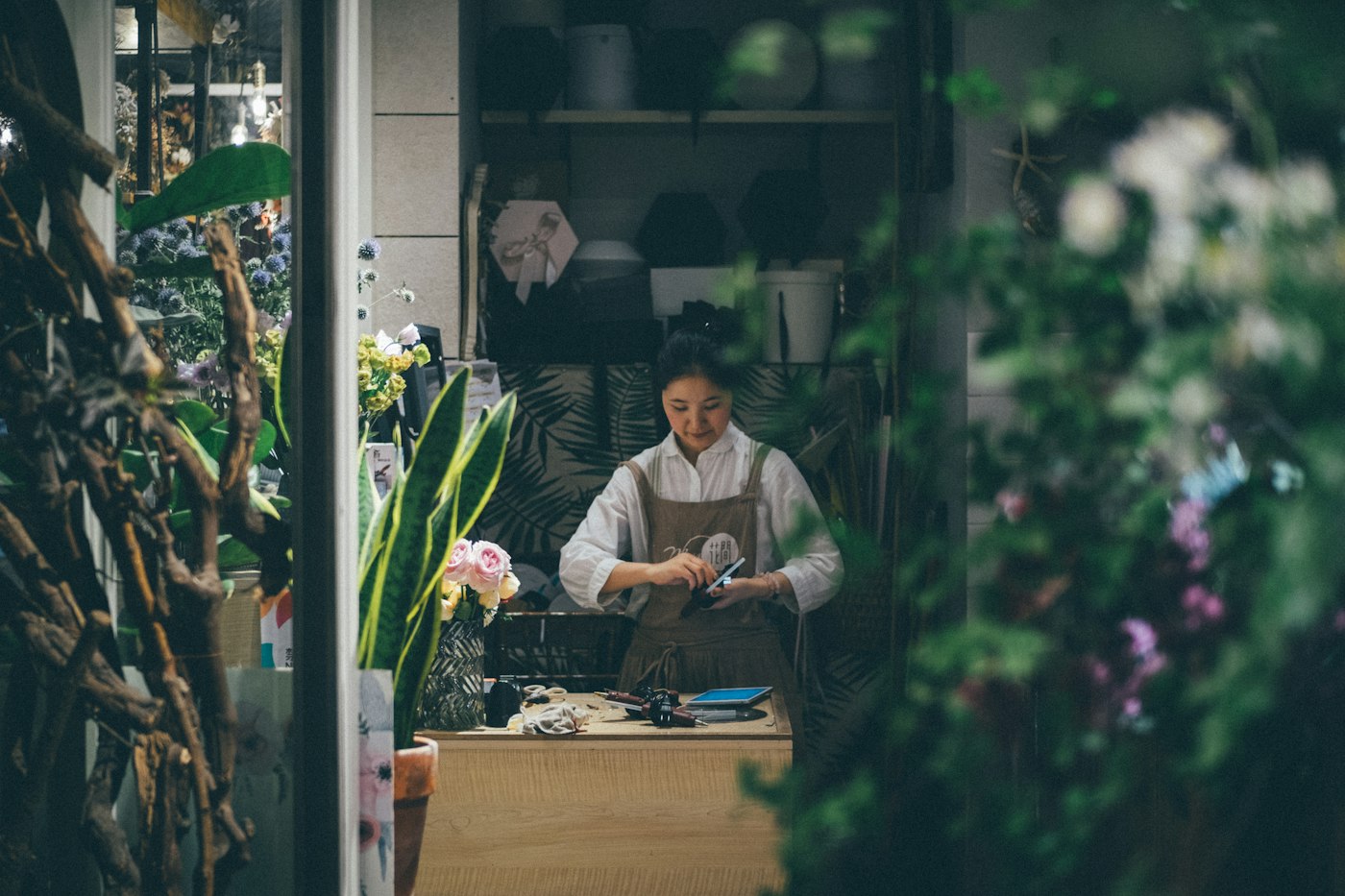 A small shop owner working in her flower shop